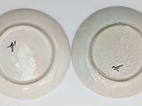 two white plates with black writing on them