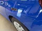 a blue car that has a sticker on the side of it