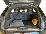the back of a car with a bed in the trunk of it