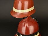 two red hard hats sitting on top of each other