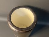a silver cup that is sitting on a table