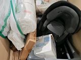 a cardboard box filled with assorted items in a room