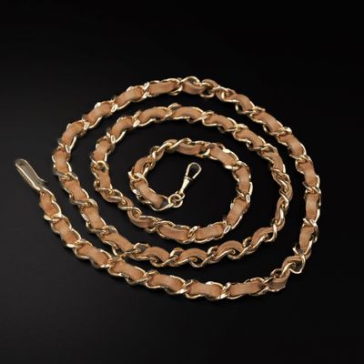 a close up of a gold chain on a black background