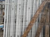 a pile of metal pipes sitting outside of a building