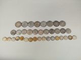 several different coins are arranged in a row on a white surface