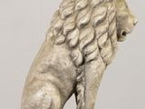 statue of a lion sitting on a wooden base