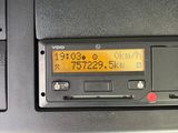 a close up of a radio on a car ' s dashboard