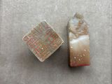 two pieces of glass on a table next to each other