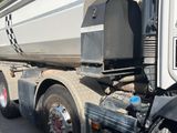 a large dump truck that is parked on the side of the road