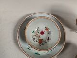 two cups and a saucer sitting on a table