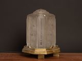 an image of a clear glass table lamp on a wooden table