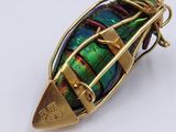 a close up of a gold and green beetle
