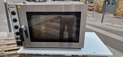 a microwave sitting on top of a table on the street