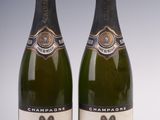 two bottles of champagne are sitting next to each other on a table