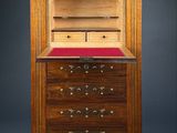 a wooden cabinet with drawers and drawers on top of it