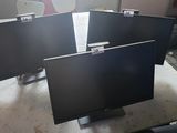 three monitors sitting on top of each other in a room