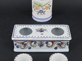 three cups and a container sitting on a table