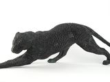figurine of a black cat running on a white surface