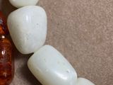 a close up of a necklace made of glass beads