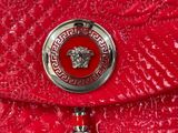 versa versa versa versa versa red clutch bag with a versa versa logo on the front