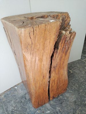a piece of wood sitting on the floor next to a wall