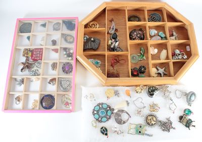 a wooden box filled with assorted jewelry on a white surface