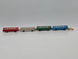 four toy buses that are lined up on a white surface