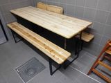 two benches and a table in a small room