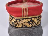 a red and black hat with gold decorations on it