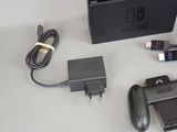 a nintendo wii game controller and a charger on a table