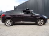 a picture of a black car parked in front of a building