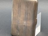 a small silver cigarette case sitting on a table