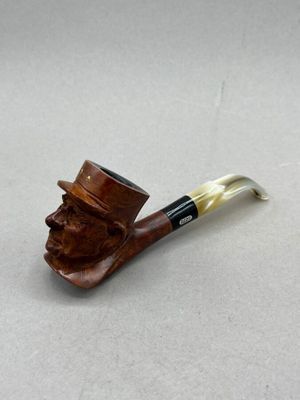 a pipe with a man ' s face on it
