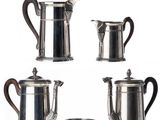 four pieces of silver tea and coffee set on a white background