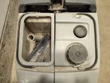 a dirty washer and a dirty dryer in a dirty room