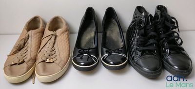 four pairs of shoes lined up in a row on a white surface