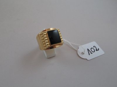 an image of a gold ring with a black stone on it