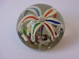 une boule de verre contenant une fleur, posée sur une table