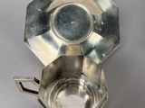 an image of a silver ashtray with a lid on a table