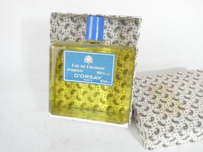 a bottle of cologne sitting next to a box of soap