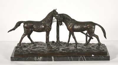 statue of two horses standing next to each other on a marble base