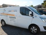 a white van that is parked in a parking lot