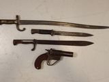 three different types of weapons are displayed on a white surface