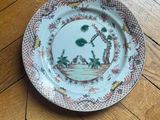 a plate on the floor that has a picture of a man and a dog on it