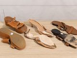several pairs of women ' s shoes are lined up on a table