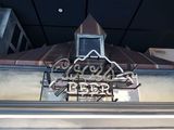 a sign on the side of a building that says cold water beer