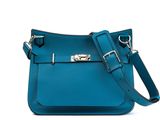 a close up of a blue purse on a white background