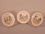 three plates with different designs on them sitting on a table