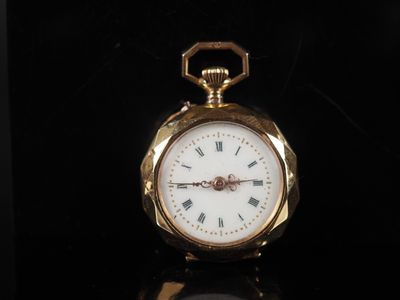 a gold pocket watch with roman numerals on the face