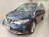the blue nissan murano is parked inside of a building